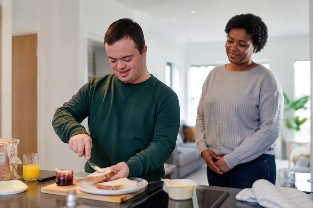 Adult preparing food with a support worker